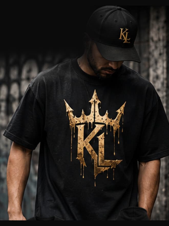 A man wearing the Crown Drip tee in black, the gold crown across the chest