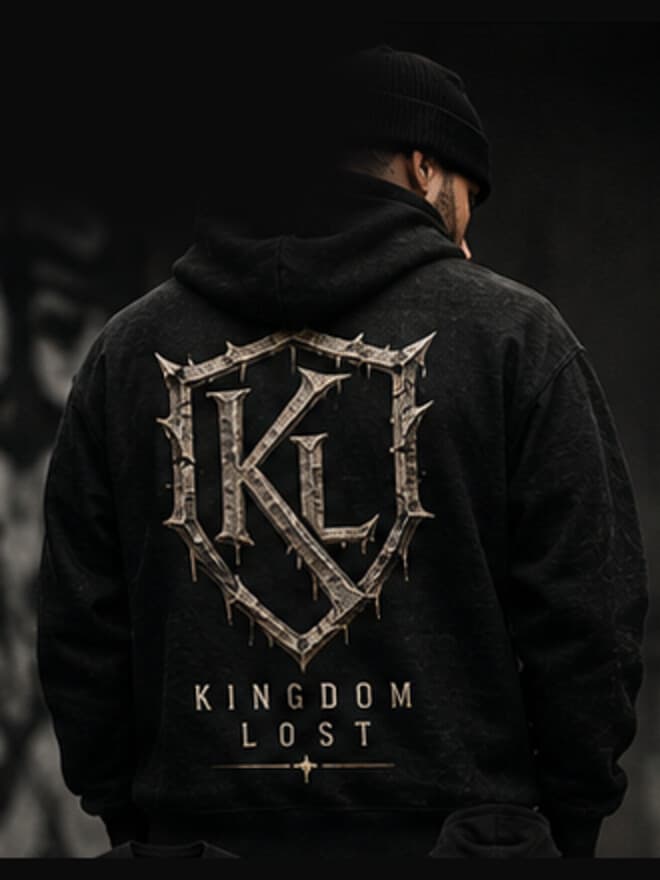 The back of a man wearing the Shield of Nothing hoodie in black, the shield printed across the back panel